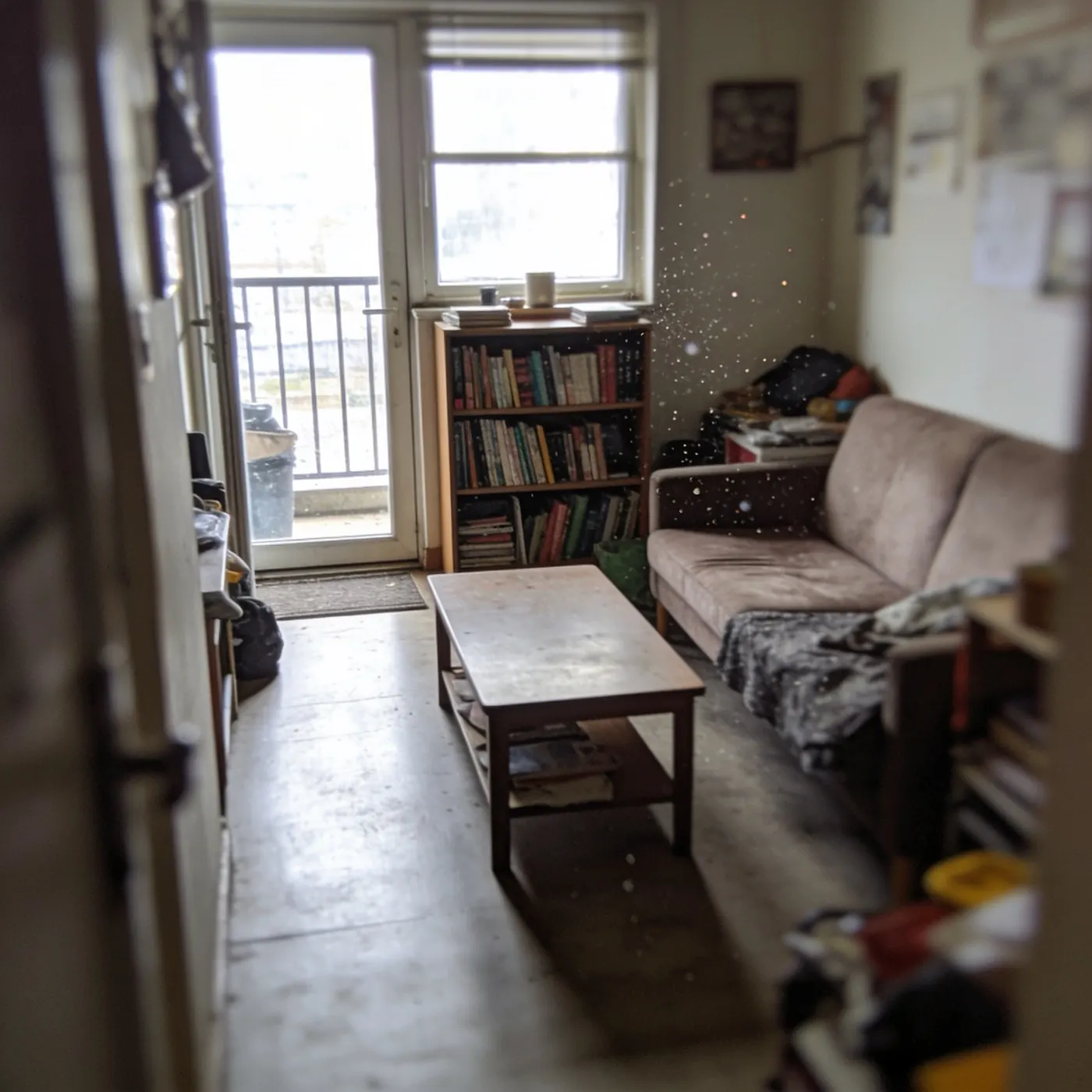The same small living room, cluttered and cramped