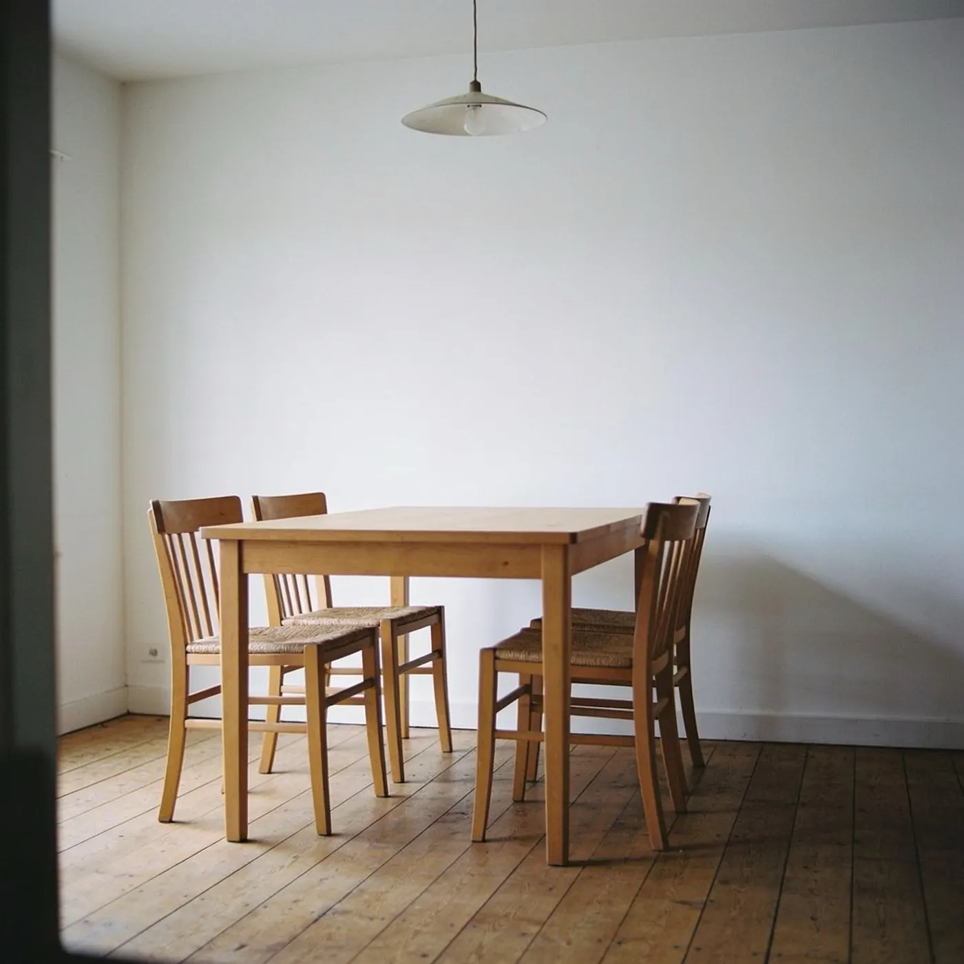 The same dining room with a plain white wall